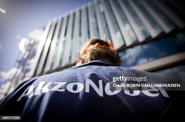 Picture taken on April 25, 2017 shows an employee of AkzoNobel at the beginning of the Annual General Meeting of shareholders in Amsterdam. - The...