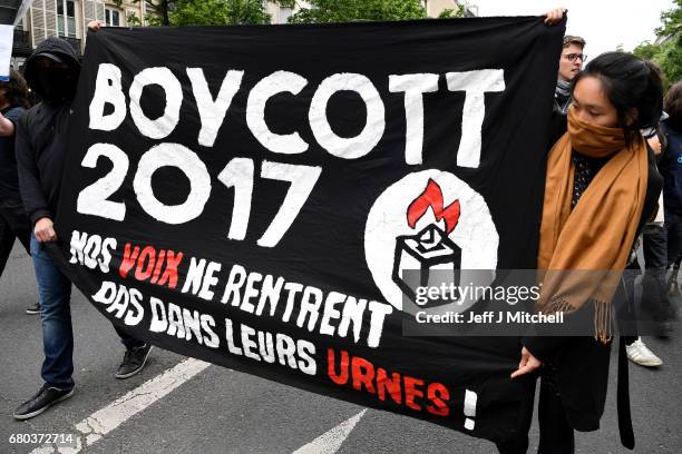 Demonstrators take part in a trade unions demonstrations against the election of Emmanuel Marcon on May 8, 2017 in Paris, France. The centrist...