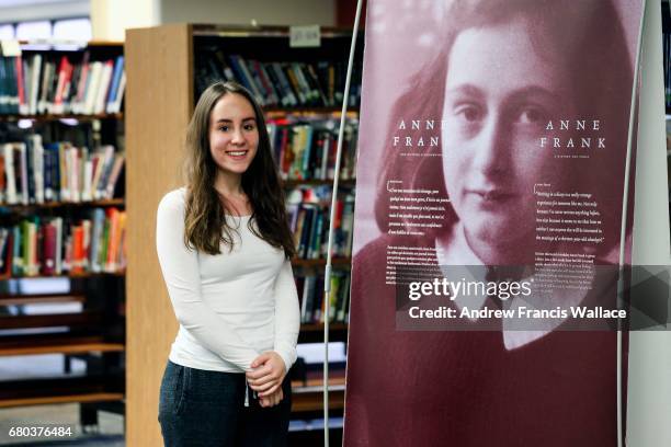 Emma Da Silva poses near a picture of Anne Frank at John Polanyi CI, May 1, 2017. An Anne Frank exhibit from her home/museum in Amsterdam comes to...