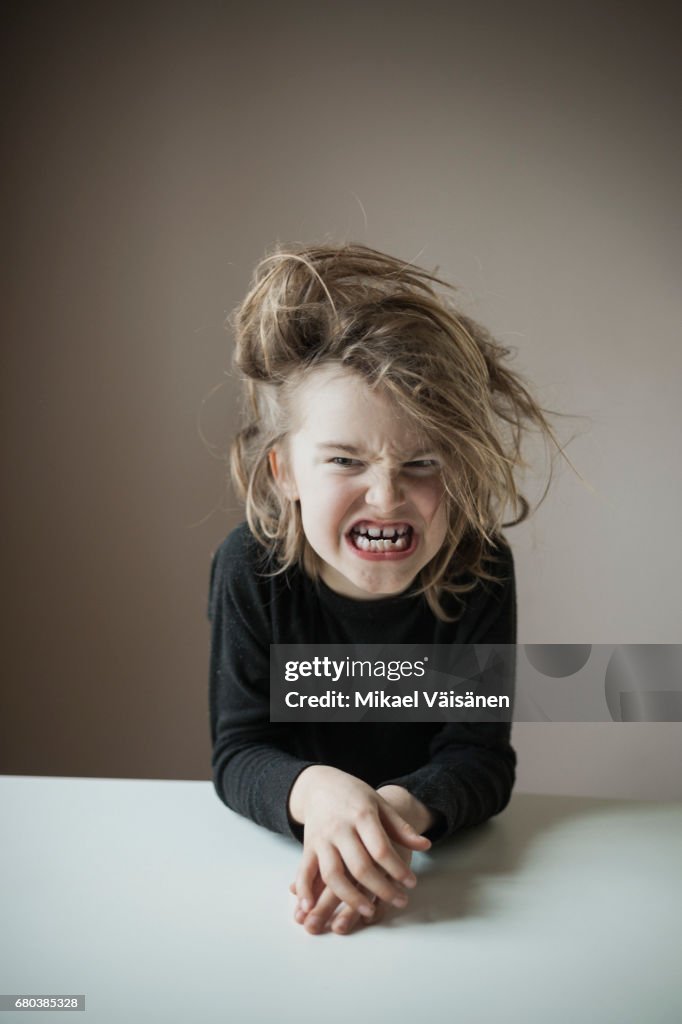 Boy with funny hairstyle making faces