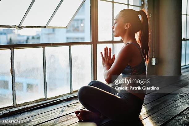 yoga in natural light studio - yoga stock pictures, royalty-free photos & images