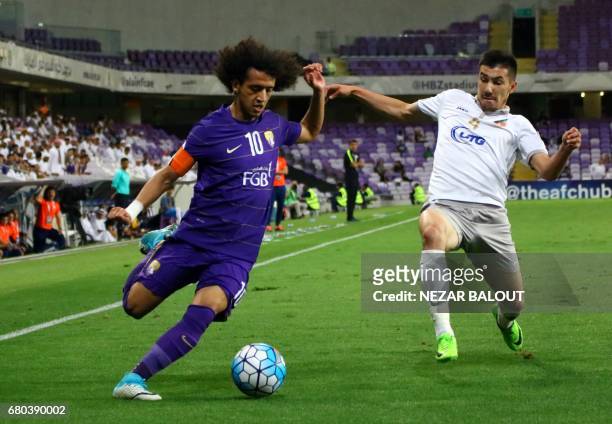 Al-Ain's Omar Abdulrahman and Bunyodkor's Komilov Akramjon vie for the ball during their AFC Champions League Group C football match at the Hazza Bin...