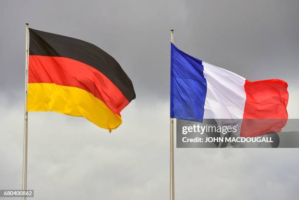 The German and French flags fly at the Chancellery in Berlin ahead of the visit of outgoing French President Francois Hollande on May 8 the day after...