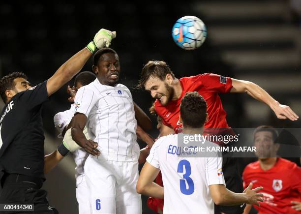 Al-Hilal's Abdulmalek Al Khaibri fights for the ball against al-Rayyan's Nathan Otávio during a AFC Champions League match between Qatar's al-Rayyan...