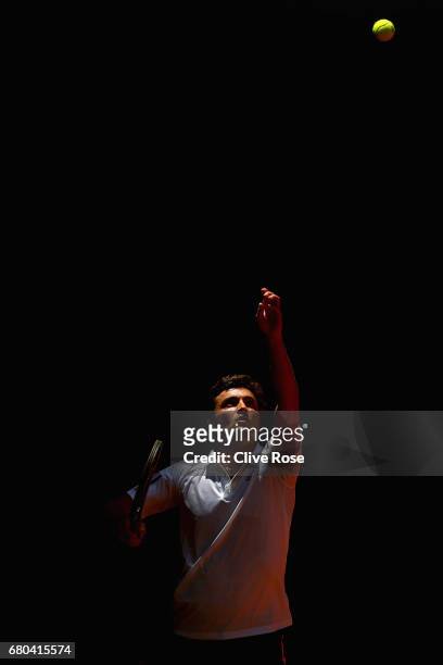 Gilles Simon of France serves during his match against Gael Monfils of France on day three of the Mutua Madrid Open tennis at La Caja Magica on May...
