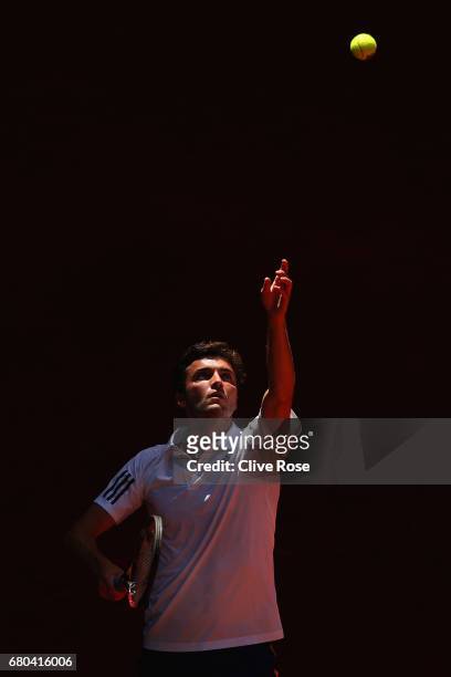 Gilles Simon of France serves during his match against Gael Monfils of France on day three of the Mutua Madrid Open tennis at La Caja Magica on May...