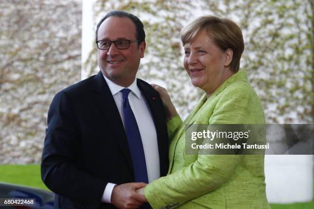 Germany's Chancellor Angela Merkel welcomes French State President Francois Hollande on his last visit to Germany ahead of their joint dinner in the...