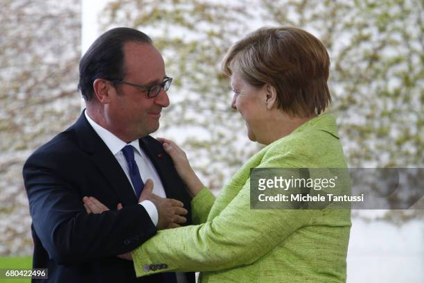 Germany's Chancellor Angela Merkel welcomes French State President Francois Hollande on his last visit to Germany ahead of their joint dinner in the...