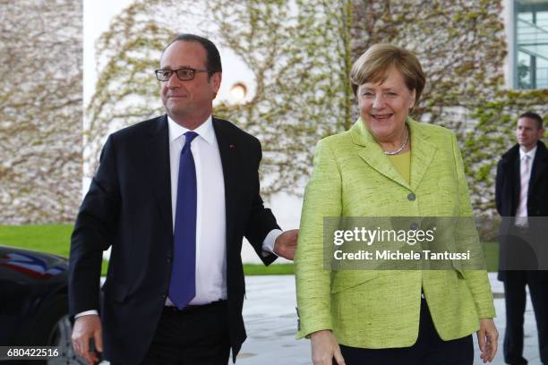 Germany's Chancellor Angela Merkel welcomes French State President Francois Hollande on his last visit to Germany ahead of their joint dinner in the...