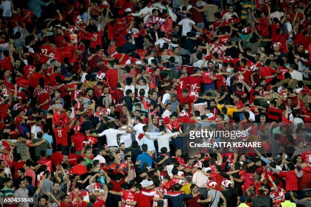 Persepolis fans cheer during the Asian Champions League football match between UAE's Al-Wahda and Iran's Persepolis at the Azadi Stadium in Tehran on...