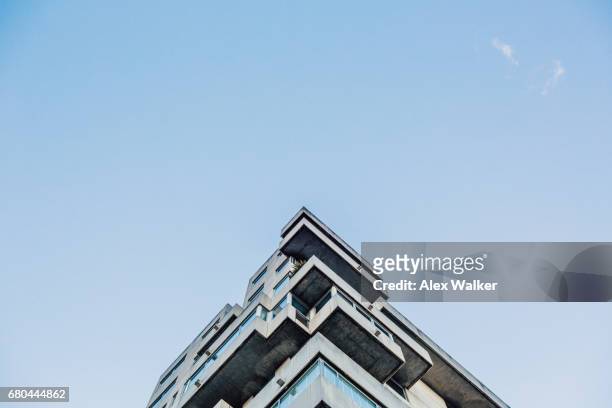 low angle view of modern residential building against blue sky - architecture detail stock pictures, royalty-free photos & images