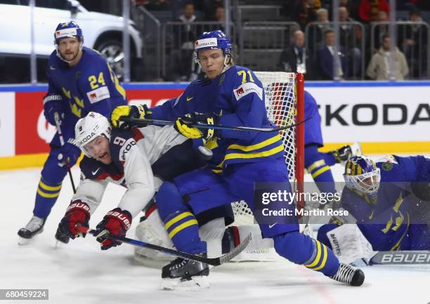 Andrew Copp of USA is challenged by William Karlsson of Sweden during the 2017 IIHF Ice Hockey World Championship game between USA and Sweden at...