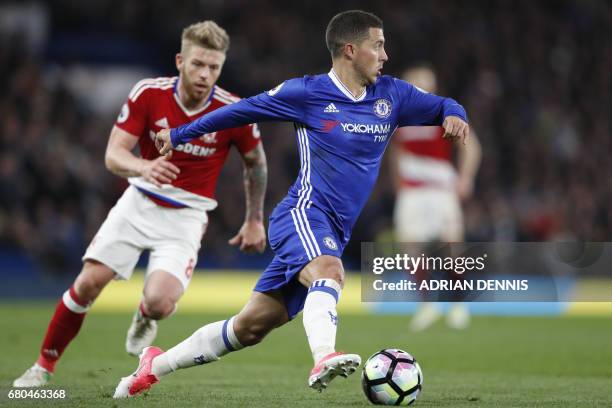 Chelsea's Belgian midfielder Eden Hazard runs past Middlesbrough's English midfielder Adam Clayton during the English Premier League football match...