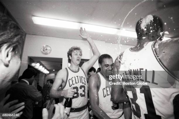 Boston Celtics players Larry Bird and Dennis Johnson celebrate the team's NBA championship in the locker room after Game 7 of the NBA Finals outside...