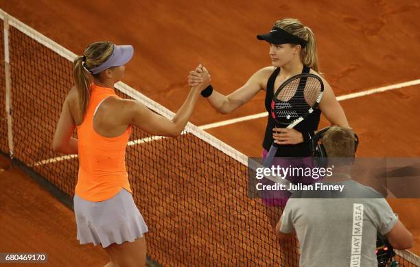 Winner in three sets Eugenie Bouchard of Canada shakes hands with Maria Sharapova of Russia during day three of the Mutua Madrid Open tennis at La...