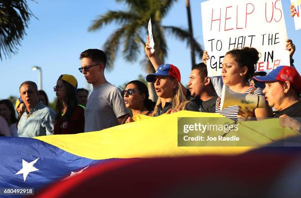 Venezuelan's protest against the Venezuelan government as Florida Governor Rick Scott hosts a Venezuelan Freedom Rally at El Arepazo 2 to show his...