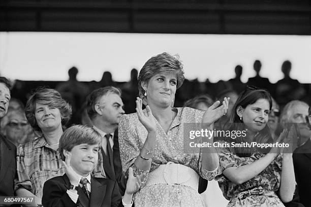 Diana, Princess of Wales and Prince William applaud and clap as they watch the final of the Ladies' Singles tournament between Argentine tennis...