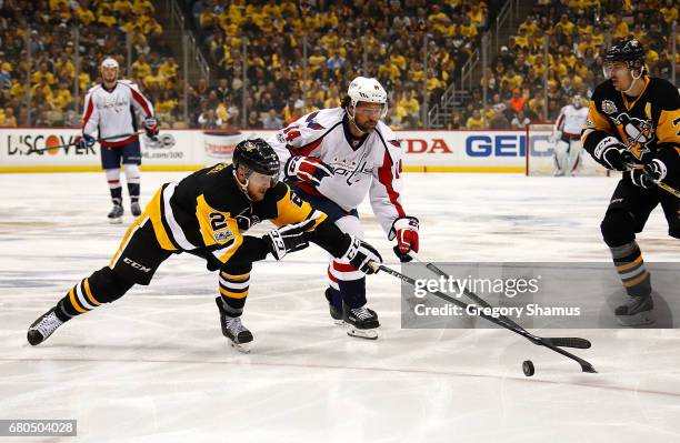 Chad Ruhwedel of the Pittsburgh Penguins skates against Justin Williams of the Washington Capitals in Game Six of the Eastern Conference Second Round...