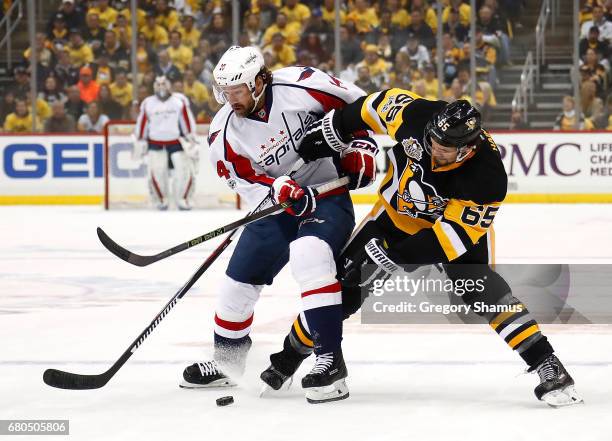 Justin Williams of the Washington Capitals skates against Ron Hainsey of the Pittsburgh Penguins in Game Six of the Eastern Conference Second Round...