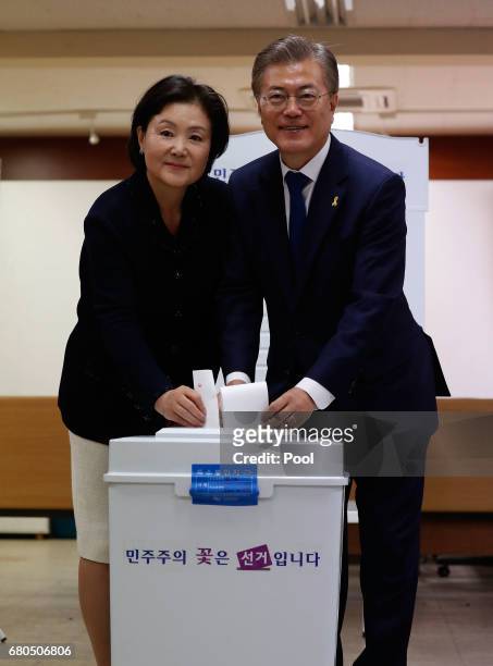 South Korean presidential candidate Moon Jae-in of the Democratic Party and his wife Kim Jung-suk prepare to cast their ballot for a presidential...