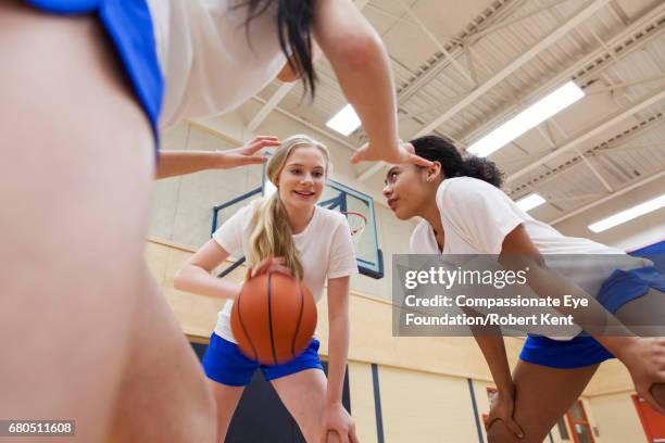 teenage students playing basketball in gym - basketball teenager stock pictures, royalty-free photos & images