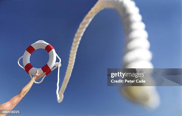 arm in air holding life ring - lifesaver stock pictures, royalty-free photos & images