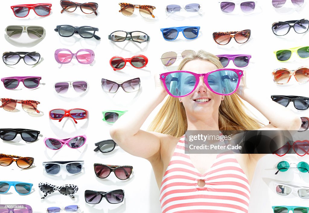 Woman wearing oversized glasses, glasses on floor