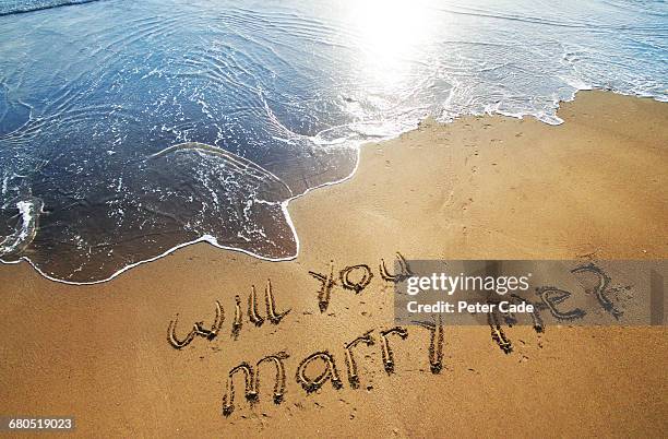 will you marry me written in sand on beach - speaking engagement stock pictures, royalty-free photos & images