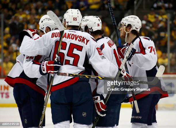 John Carlson of the Washington Capitals celebrates his goal against the Pittsburgh Penguins with Justin Williams and Andre Burakovsky in Game Six of...
