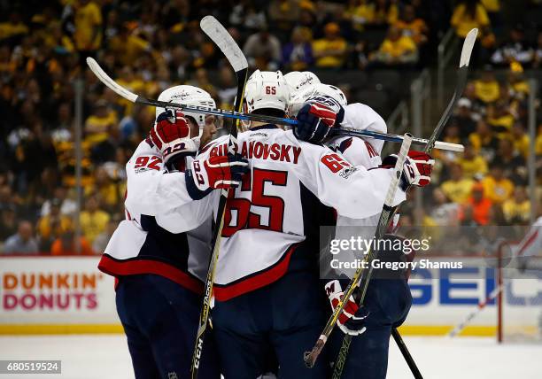 John Carlson of the Washington Capitals celebrates his goal against the Pittsburgh Penguins with Justin Williams, Evgeny Kuznetsov and Andre...