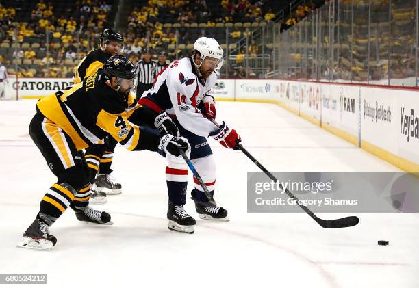 Justin Williams of the Washington Capitals skates against Justin Schultz of the Pittsburgh Penguins in Game Six of the Eastern Conference Second...