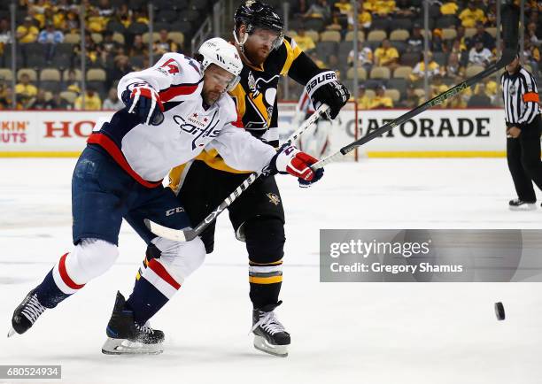 Justin Williams of the Washington Capitals skates against Phil Kessel of the Pittsburgh Penguins in Game Six of the Eastern Conference Second Round...