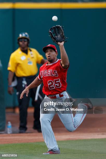 Ben Revere of the Los Angeles Angels of Anaheim catches a foul ball off the bat of Jed Lowrie of the Oakland Athletics during the first inning at the...
