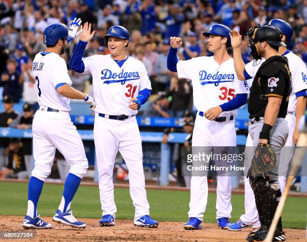 Chris Taylor of the Los Angeles Dodgers celebrates his grand slam homerun to take a 5-0 lead with Joc Pederson, Cody Bellinger and Corey Seager as...