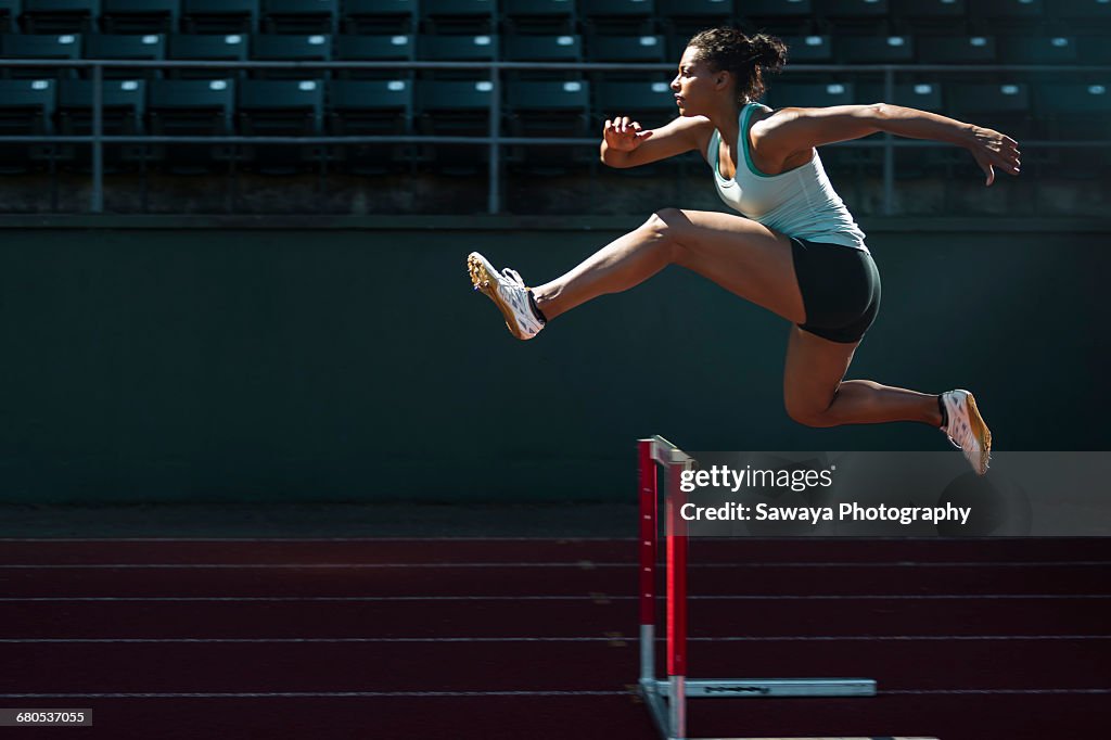 A runner taking on the hurdles.