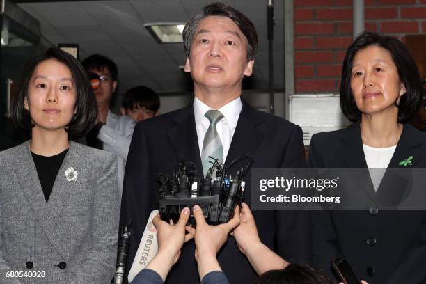 Ahn Cheol-soo, presidential candidate of the People's Party, center, speaks to members of media as his wife Kim Mi-kyung, right, and daughter Ahn...