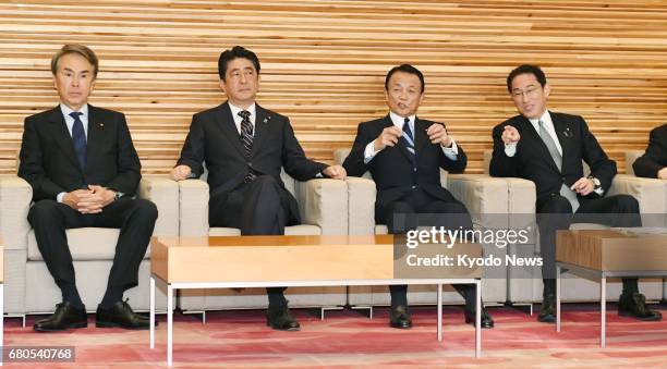 Japanese Prime Minister Shinzo Abe attends a regular Cabinet meeting in Tokyo on May 9 alongside Nobuteru Ishihara , minister in charge of economic...