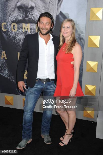 Actor Zach McGowan and Emily Johnson arrive at the premiere of Warner Bros. Pictures' "King Arthur: Legend Of The Sword" at TCL Chinese Theatre on...