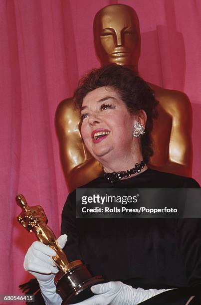 American actress Rosalind Russell pictured holding an Oscar statuette as she attends the 43rd Academy Awards at the Dorothy Chandler Pavilion in Los...