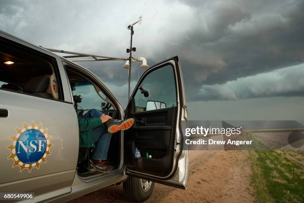 Support scientist Tim Marshall, a 40 year veteran of storm chasing, relaxes in the tornado scout vehicle during the last storm of their day, May 8,...