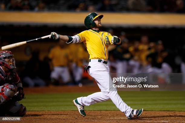 Jed Lowrie of the Oakland Athletics hits a walk-off home run during the eleventh inning against the Los Angeles Angels of Anaheim at the Oakland...