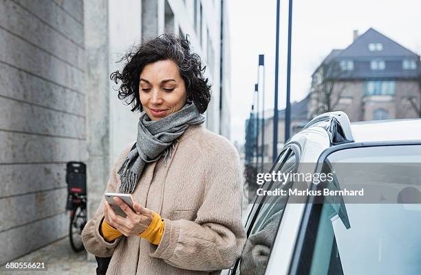 woman texting with cellphone - architectural elements stock-fotos und bilder