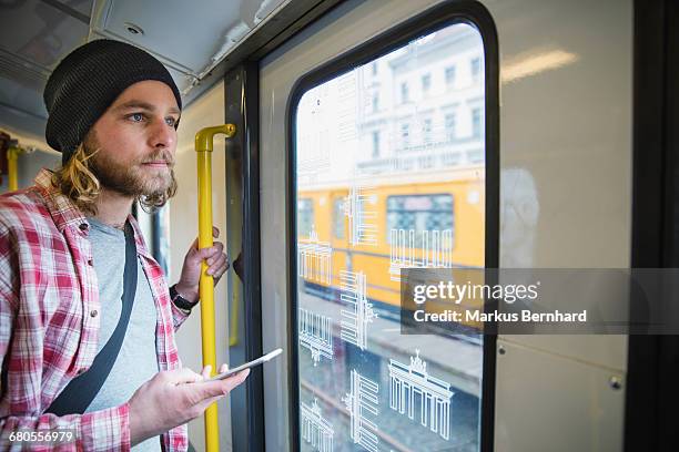 young man taking the subway - u bahn stock-fotos und bilder