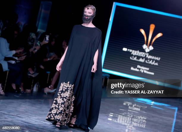 Model wears a creation by Kuwaiti designer Rasha al-Wazzan during the Kuwait fashion week in Kuwait City on May 8,2017. / AFP PHOTO / Yasser Al-Zayyat