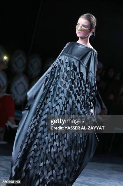 Model wears a creation by Kuwaiti designer Rasha al-Wazzan during the Kuwait fashion week in Kuwait City on May 8,2017. / AFP PHOTO / Yasser Al-Zayyat