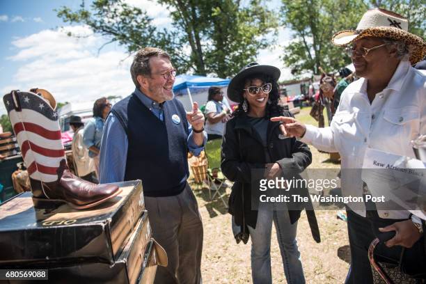 Archie Parnell, left, shares a laugh with Florida residents Antonette [sic] Addison, center, and Rutha [sic] Jackson during the annual Black Cowboy...
