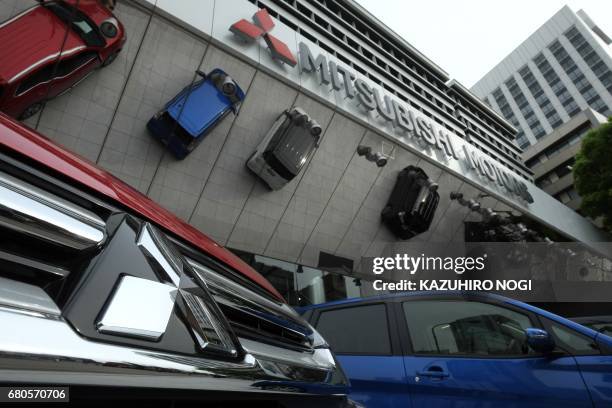 This picture shows the logo of Japan's Mitsubishi Motors Corporation displayed at the company's head office in Tokyo on May 9, 2017. Mitsubishi...