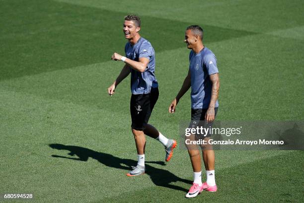 Cristiano Ronaldo of Real Madrid CF laughs behind his teammate Danilo Luiz da Silva during a training session ahead of the UEFA Champions League...