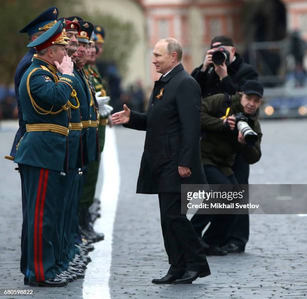 Russian President Vladimir Putin greets the military as he attends the Victory Day military parade to celebrate the 72nd anniversary of the victory...