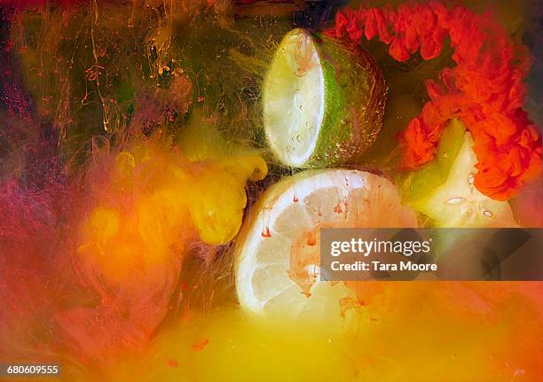 citrus fruit and ink shot underwater - bright food stock pictures, royalty-free photos & images